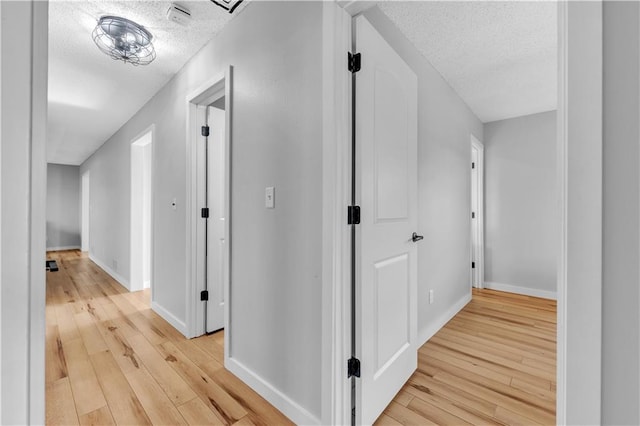 252 SE 23rd Hwy, Knob Noster, MO 65336 - hallway featuring a textured ceiling, light wood-style flooring, and baseboards