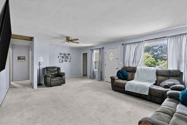 4305 Doctor Greaves Rd, Grandview, MO 64030 - living area featuring light carpet, plenty of natural light, ceiling fan, and baseboards