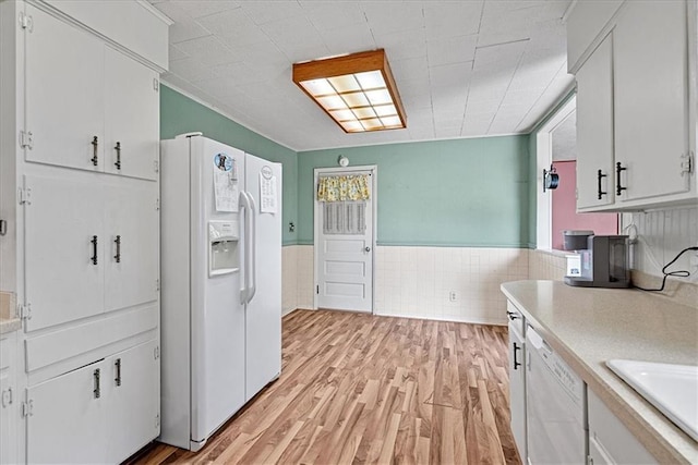 4305 Doctor Greaves Rd, Grandview, MO 64030 - kitchen featuring white appliances, light countertops, white cabinetry, light wood-style floors, and wainscoting