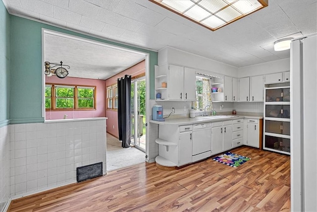 4305 Doctor Greaves Rd, Grandview, MO 64030 - kitchen featuring open shelves, white dishwasher, light countertops, white cabinets, and healthy amount of natural light