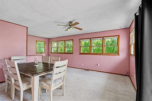 4305 Doctor Greaves Rd, Grandview, MO 64030 - dining area featuring ceiling fan, a textured ceiling, baseboards, and light colored carpet