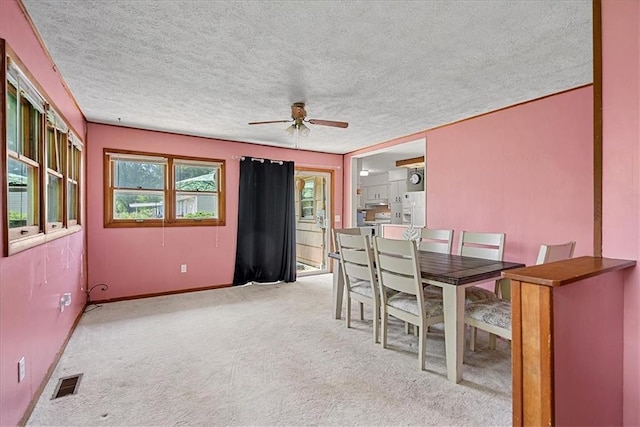 4305 Doctor Greaves Rd, Grandview, MO 64030 - carpeted dining space featuring ceiling fan, a textured ceiling, and baseboards