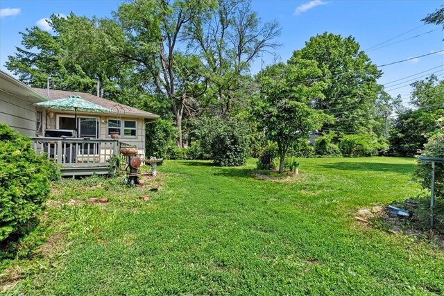 4305 Doctor Greaves Rd, Grandview, MO 64030 - view of grassy yard featuring a deck and view of scattered trees