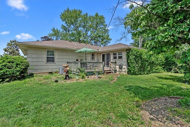 4305 Doctor Greaves Rd, Grandview, MO 64030 - rear view of property featuring a wooden deck and a yard