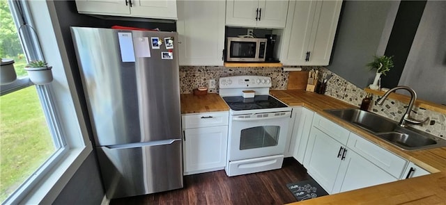 708 S Gay St, Holden, MO 64040 - kitchen featuring stainless steel appliances, a sink, healthy amount of natural light, and white cabinets
