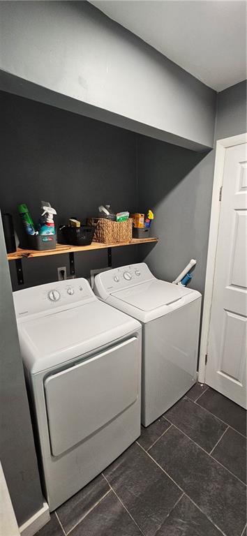 708 S Gay St, Holden, MO 64040 - laundry area with washer and clothes dryer and dark tile patterned floors