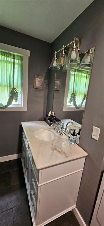 708 S Gay St, Holden, MO 64040 - bathroom featuring vanity and baseboards