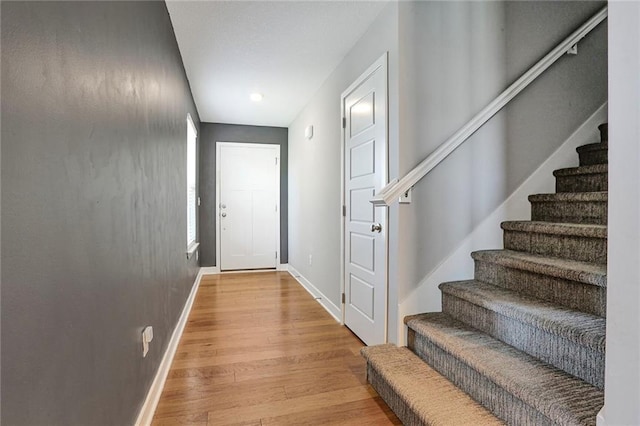 doorway to outside with stairs, baseboards, light wood-type flooring, and recessed lighting