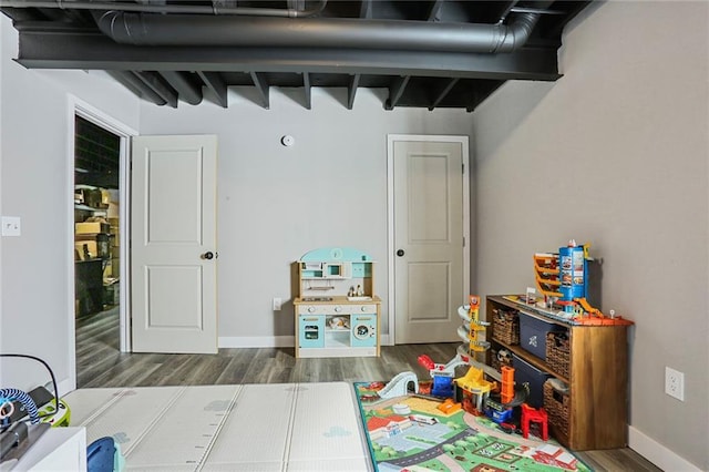 bedroom featuring wood finished floors and baseboards