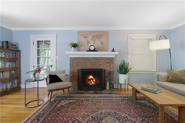23 W Winthrope Rd, Kansas City, MO 64113 - living area featuring crown molding, wood finished floors, a brick fireplace, and baseboards