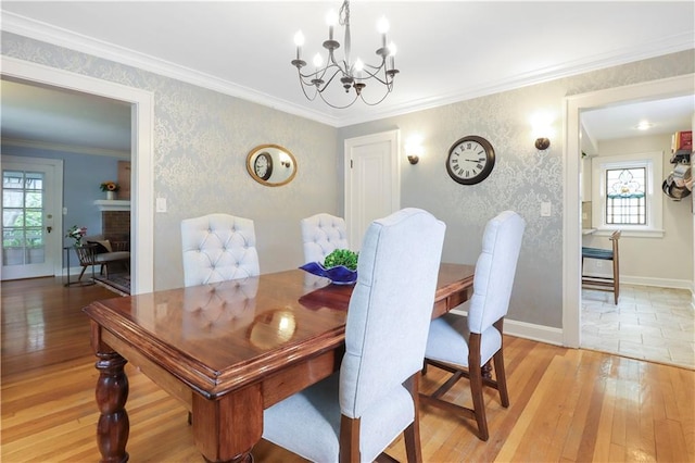 23 W Winthrope Rd, Kansas City, MO 64113 - dining area with a chandelier, light wood-style flooring, baseboards, and wallpapered walls