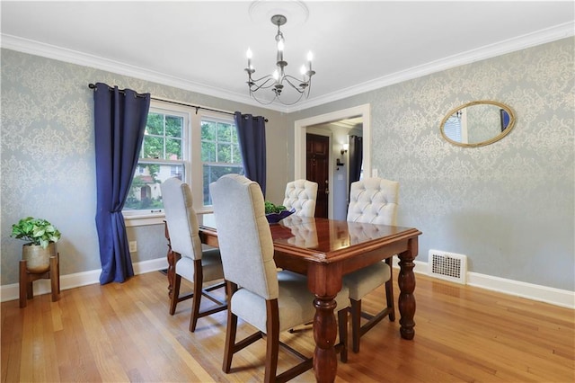 23 W Winthrope Rd, Kansas City, MO 64113 - dining room with a chandelier, light wood-style floors, wallpapered walls, crown molding, and baseboards