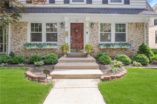 23 W Winthrope Rd, Kansas City, MO 64113 - entrance to property featuring brick siding, a lawn, and roof with shingles