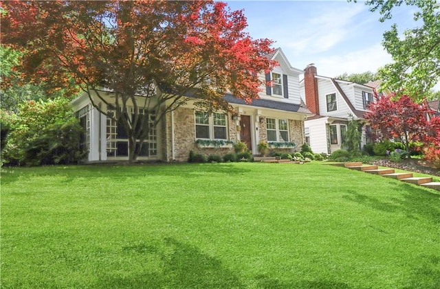 23 W Winthrope Rd, Kansas City, MO 64113 - view of front facade featuring a front yard, a chimney, and stone siding