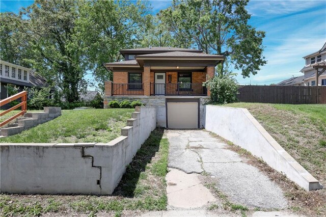 2414 N 12th St, Kansas City, KS 66104 - view of front of house featuring brick siding, driveway, and an attached garage