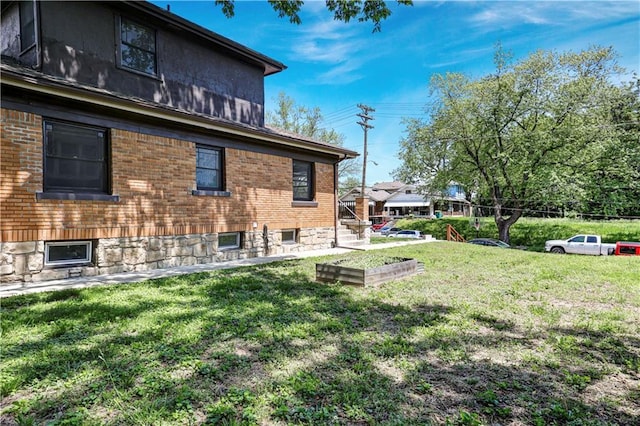 2414 N 12th St, Kansas City, KS 66104 - rear view of house with a lawn and brick siding