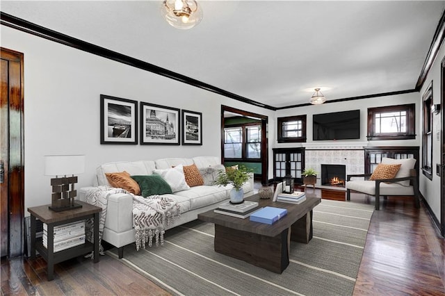 2414 N 12th St, Kansas City, KS 66104 - living area featuring ornamental molding, dark wood finished floors, a fireplace, and baseboards