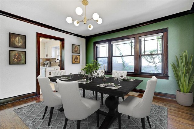 2414 N 12th St, Kansas City, KS 66104 - dining room featuring crown molding, baseboards, a chandelier, and dark wood-style floors