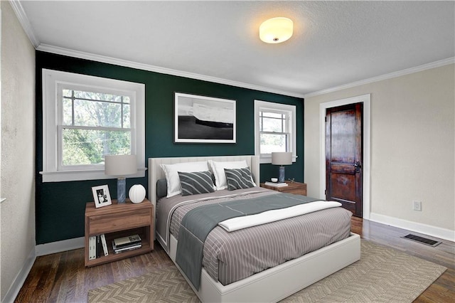 2414 N 12th St, Kansas City, KS 66104 - bedroom featuring ornamental molding, wood finished floors, and baseboards