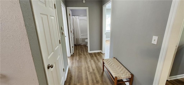 7934 Hemlock St, Overland Park, KS 66204 - corridor featuring wood finished floors and baseboards