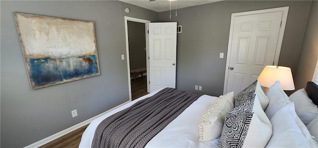 7934 Hemlock St, Overland Park, KS 66204 - bedroom featuring wood finished floors, baseboards, and a textured ceiling