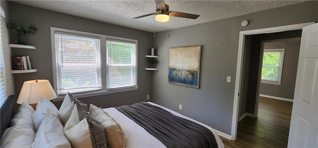 7934 Hemlock St, Overland Park, KS 66204 - bedroom with a textured ceiling, wood finished floors, ceiling fan, and baseboards