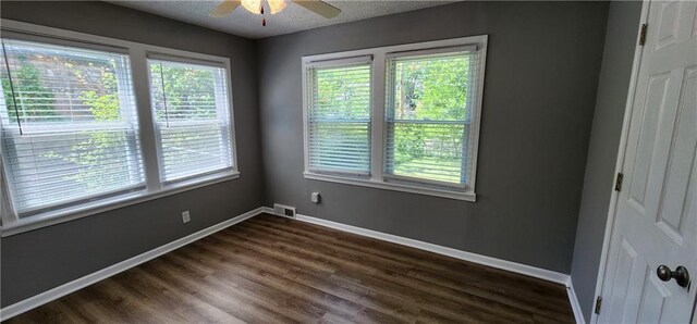 7934 Hemlock St, Overland Park, KS 66204 - empty room with healthy amount of natural light, ceiling fan, dark wood-type flooring, baseboards, and a textured ceiling
