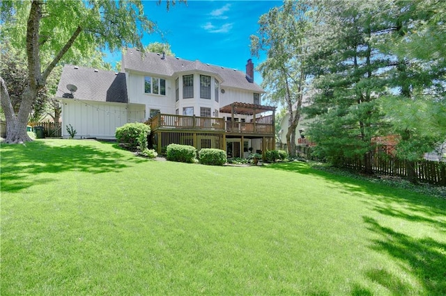 back of property featuring a deck, a chimney, and board and batten siding