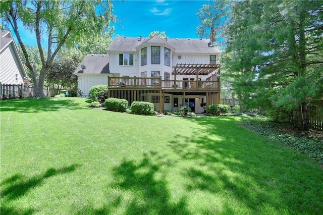 rear view of property with a pergola and a deck