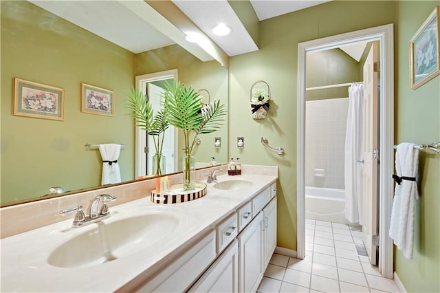 bathroom featuring tile patterned floors, double vanity, shower / bath combo with shower curtain, and baseboards