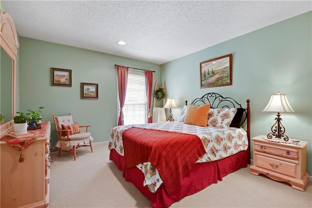 bedroom with light carpet, recessed lighting, a textured ceiling, and baseboards