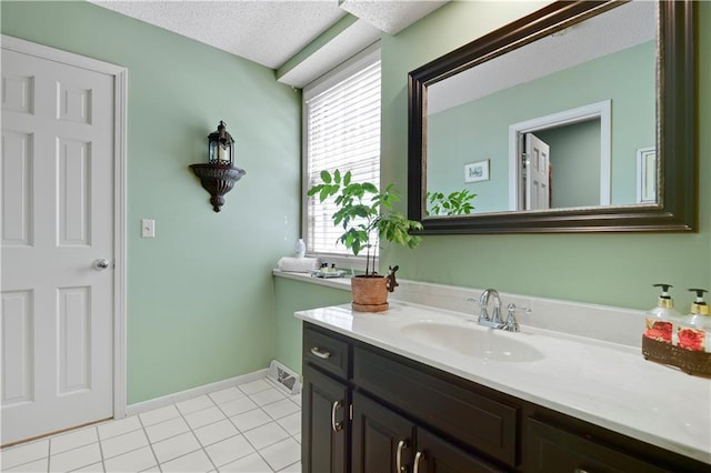 bathroom featuring tile patterned floors, vanity, and baseboards