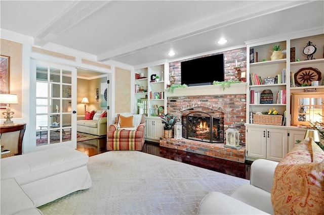 bedroom with beamed ceiling, a fireplace, and dark wood-style flooring
