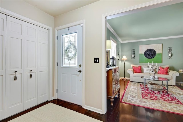 entrance foyer featuring baseboards, healthy amount of natural light, dark wood-type flooring, and ornamental molding