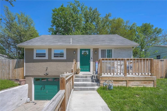 3118 Kimball Ave, Kansas City, KS 66104 - view of front facade with a garage, fence, and stucco siding