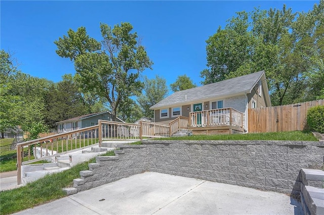 3118 Kimball Ave, Kansas City, KS 66104 - view of front of property with a patio area, a deck, fence, and stairs