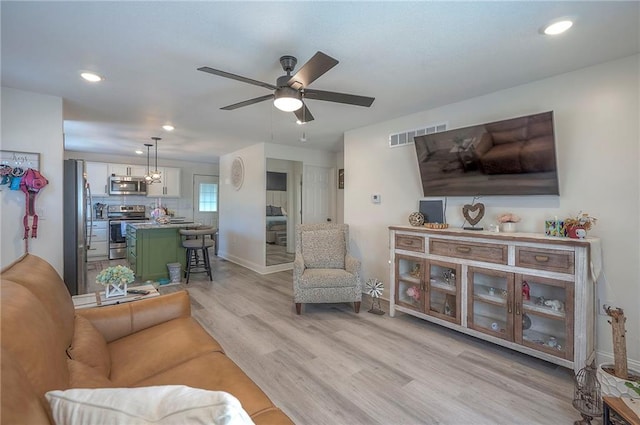 3118 Kimball Ave, Kansas City, KS 66104 - living room featuring light wood-style floors, baseboards, ceiling fan, and recessed lighting
