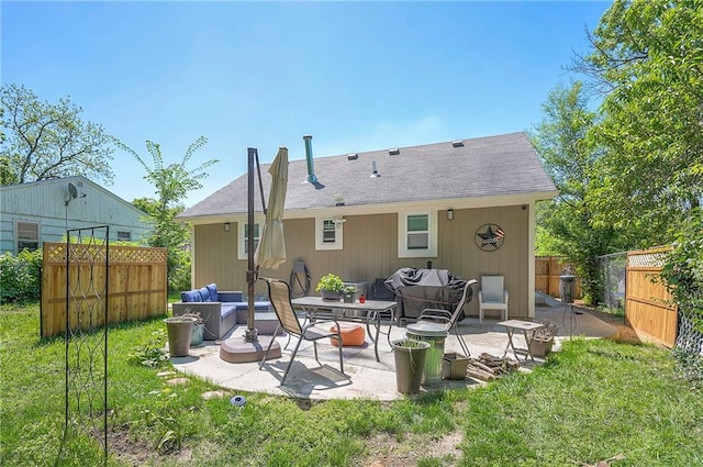 3118 Kimball Ave, Kansas City, KS 66104 - back of property featuring a patio, an outdoor hangout area, and a shingled roof