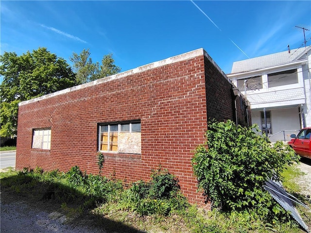 view of side of home featuring brick siding