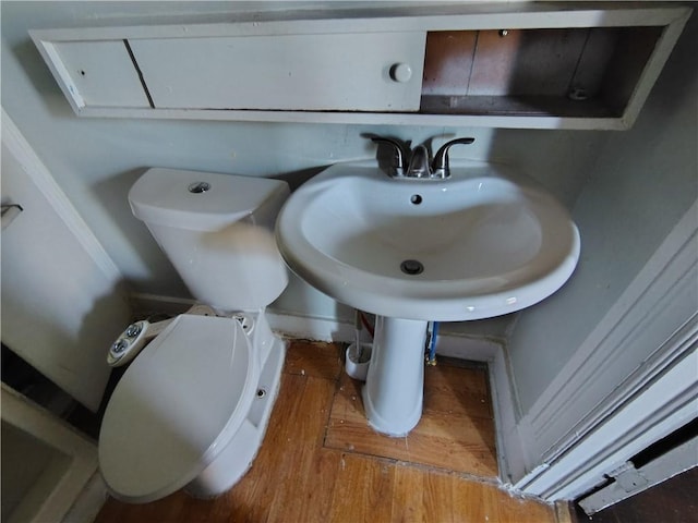 bathroom with wood finished floors and toilet