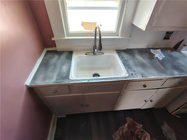 kitchen view of a sink and wood finished floors