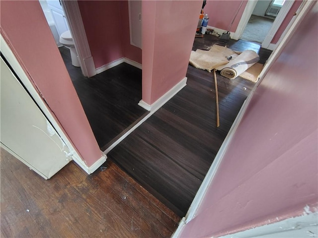 stairs with wood finished floors and baseboards