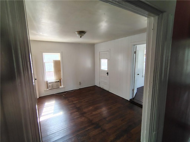 foyer entrance featuring healthy amount of natural light, dark wood-type flooring, and cooling unit