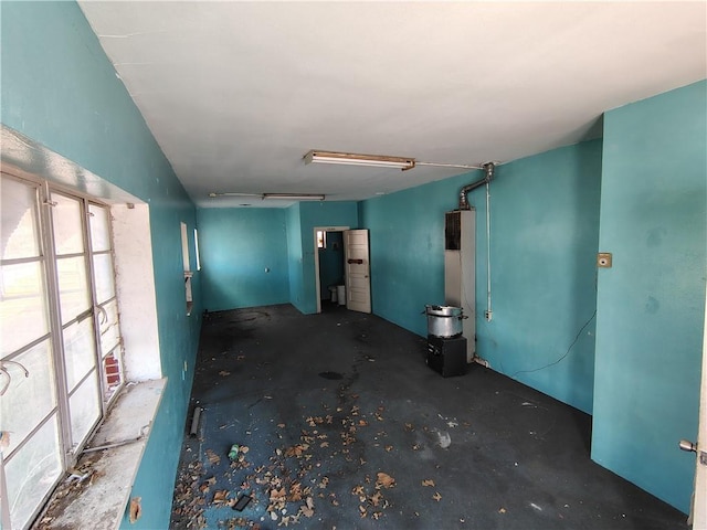 unfurnished room with unfinished concrete floors