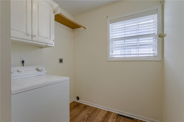 206 SW Chartwell Dr, Lees Summit, MO 64082 - clothes washing area with washer / dryer, cabinet space, wood finished floors, and baseboards