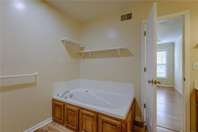 206 SW Chartwell Dr, Lees Summit, MO 64082 - full bath with a whirlpool tub, baseboards, wood finished floors, and vanity