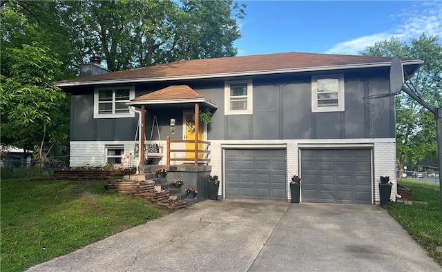 raised ranch with brick siding, a garage, driveway, and a chimney