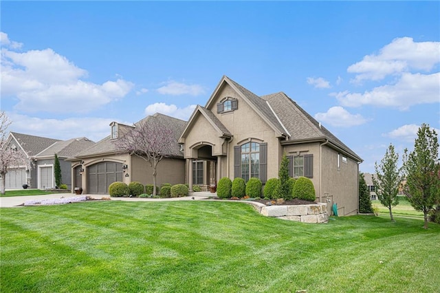 2804 NE 102nd Ter, Kansas City, MO 64155 - french country inspired facade with a front lawn, an attached garage, stucco siding, and concrete driveway