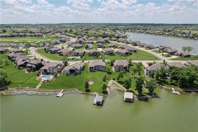 aerial view of property's location with a nearby body of water and nearby suburban area