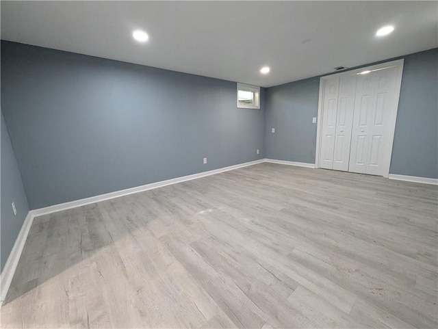below grade area featuring light wood-style floors, baseboards, and recessed lighting